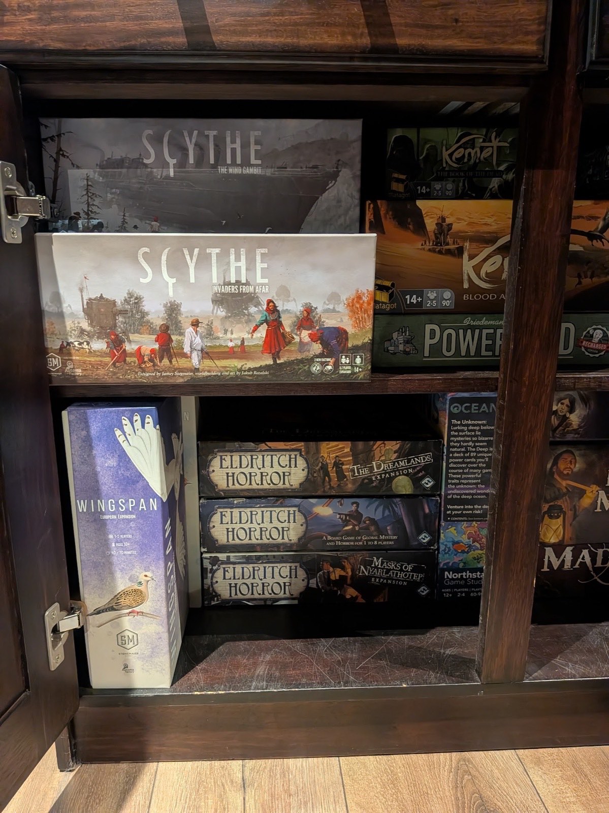 Shelf with Eldritch Horror and its expansions, Scythe and Wingspan